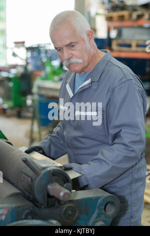 Senior in der Werkstatt Stockfoto