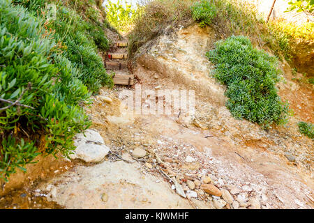 Schmale Passage durch den Korridor in Rock mit geschnitzten Treppe. Stockfoto