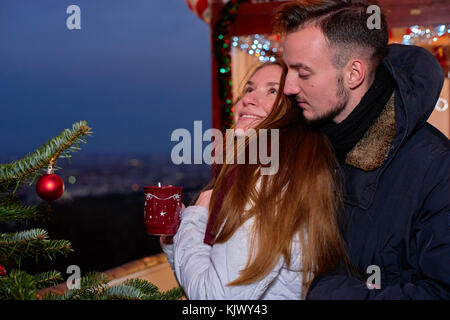 Junge glückliches Paar am Weihnachtsmarkt Stockfoto