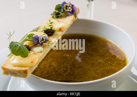 Stilvolle gourmet Zwiebelsuppe dekoriert mit Toast Scheibe Stockfoto