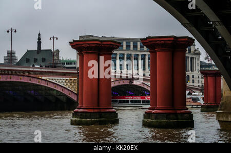 Stillgelegte viktorianische Brücke Beiträge der Viktorianischen Blackfriars Railway Bridge, mit Unilever Haus, Themse, London, England, UK, auf Misty nassen Tag Stockfoto