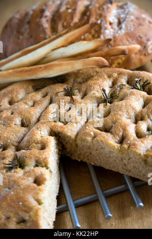 Auswahl an handgefertigten italienischen Brotsorten mit Rosmarin, Olivenöl und Meersalz Stockfoto