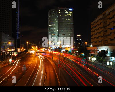 Blick von oberhalb der Straße an einem Austausch mit vorbeifahrenden Autos leichte Wanderwege in der Nacht Stockfoto