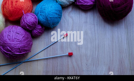 Kugeln der Kammgarn aus Wolle zum Stricken auf dem Tisch. warme Kleidung mad Stockfoto