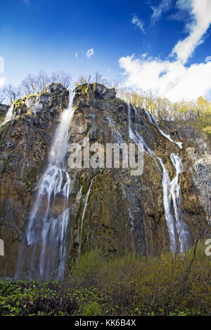 Plitvicer Seen mit einem großen Wasserfall unter dem blauen Himmel, Nationalpark in Kroatien. Stockfoto