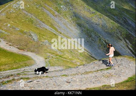 Nationalpark Lake District, Cumbria, England. Frau und Border Collie Hund zu Fuß auf der Ostflanke des Blencathra über Skalen Tarn Stockfoto