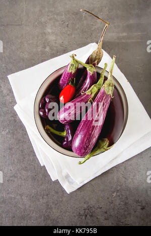 Kleine Auberginen, Tomaten. dunklen Hintergrund. vegetarisches Essen aus dem Dorf Stockfoto