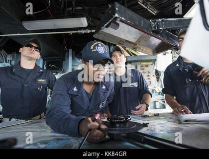 Quartiermeister 3. Klasse Kariah Stocker, von Jacksonville, Florida Grundstücke einen Kurs auf der Brücke, während sie in den Hafen an Bord des Amphibischen dock Landung Schiff USS Germantown LSD 42, weißen Strand, Okinawa. Bild mit freundlicher Genehmigung von Massenkommunikation Specialist 2. Klasse wird Gaskill/US Navy, Japan, 2015. Stockfoto