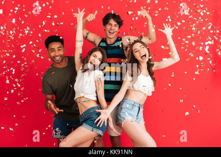 Porträt eines lächelnden fröhliche Gruppe von Multirassischen Freunde im Sommer Kleidung Spaß beim gemeinsam tanzen und feiern mit confetti isoliert Stockfoto