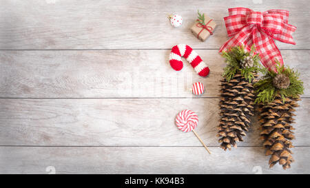 Festliche Winterurlaub Holz Hintergrund mit Ornamenten, aus Gewirken Ornament, Süßigkeiten und Kiefer - Kegel. Stockfoto