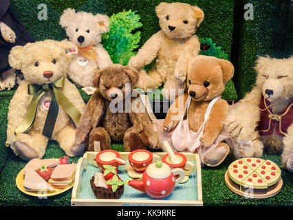Eine Gruppe von Teddybären in ein spielzeuggeschäft Fenster angezeigt bei einem Picknick. Stockfoto