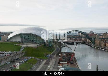 Auf der Suche nach der Sage in Gateshead, von den Zimmer in der Ostsee und den Fluss Tyne Brücken im Hintergrund und der Newcastle upon Tyne skyline Stockfoto