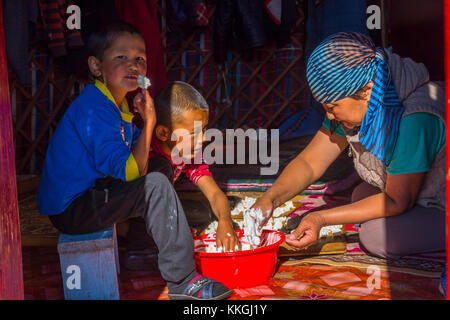 Song kul, Kirgisistan - 11. August: Frau und zwei Kinder, kurut, traditionelle Käse Kugeln in einer Jurte. august 2016 Stockfoto