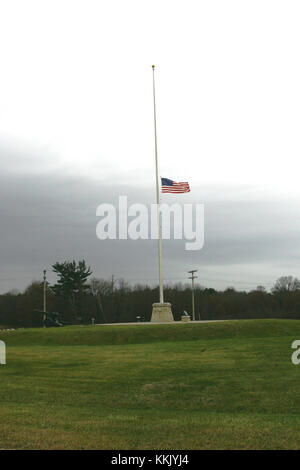 Die US-Flagge an der Hälfte - Personal, das vom Präsidenten zu bestellen, auf dem Fort McCoy Fahnenmast vor der Garnison Sitz 16. November 2015, die Opfer der Nov. 13, 2015 zu Ehren, Terroranschlag in Paris, Frankreich. Das Flag flog an der Hälfte - Mitarbeiter durch Sonnenuntergang 07.11.19. (U.S. Armee Foto von Scott T. Sturkol, Public Affairs Office, Fort McCoy, Wis.) Stockfoto