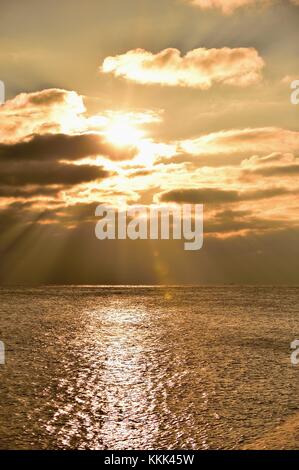 Licht Strömen vom Himmel wie die Sonne über Gewitterwolken über dem Lake Michigan an der Küste von Montrose Hafen in Chicago, Illinois, USA bricht. Stockfoto