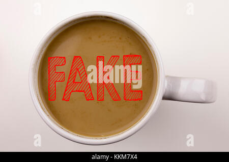 Ich schreibe Fake News-Text in Kaffee in der Tasse. Geschäftskonzept für Fake News auf weißem Hintergrund mit Platz. Schwarzer Text mit rotem Wort. Stockfoto