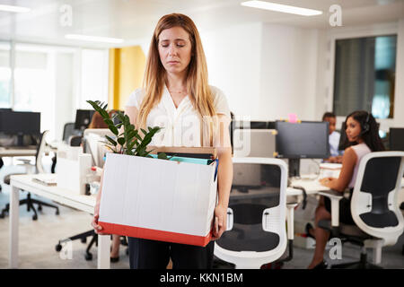 Feuerte weiblicher Angestellter Holding Box von Hab und Gut in einem Büro Stockfoto