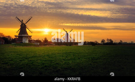 Die berühmten Twin Mühlen von Greetsiel, Ostfriesland bei Sonnenaufgang Stockfoto