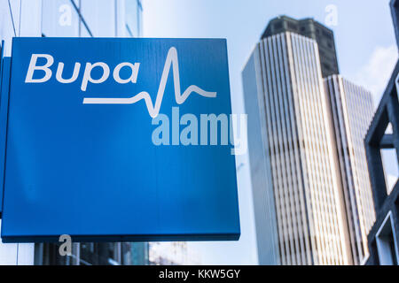 BUPA-Beschilderung mit dem Leadenhall Building (Tower 42) im Hintergrund, London, EC2, Großbritannien. Stockfoto