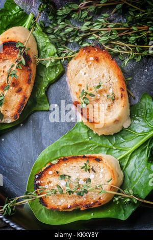 Fried Bread Croutons mit Thymian und Spinatblätter auf Silber fach Ansicht von oben Stockfoto