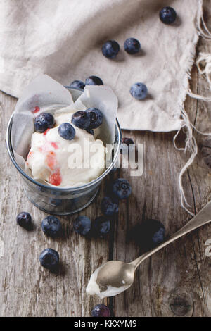 Eis, in wenig Metall Eimer mit Blaubeeren auf alten hölzernen Tisch serviert Stockfoto