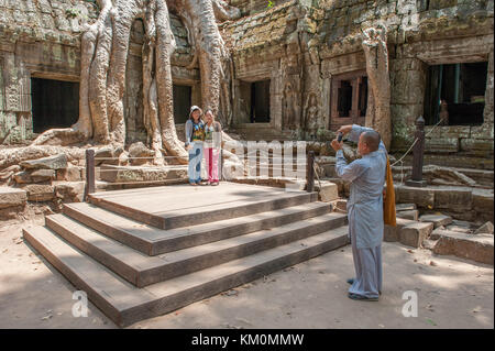 Touristen posieren bei Ta Prohm in Siem Reap. Erbaut im 12./13. Jahrhundert Ta Prohm Tempel war später Schauplatz des Films Tomb Raider. Stockfoto