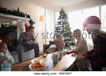 Familie Weihnachtsgeschenke im Wohnzimmer öffnen