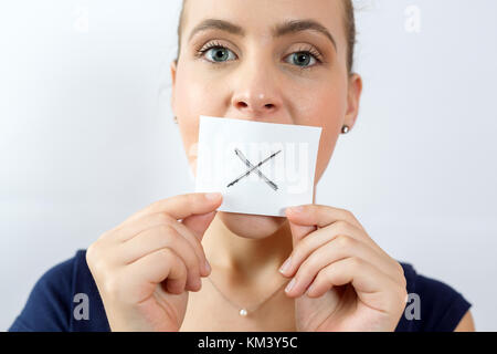 Nahaufnahme Portrait von Junge attraktive Frau mit Mund und Lippen versiegelt mit weißes Quadrat mit X Zeichen. Stockfoto