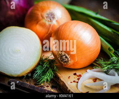 Bunte Zwiebeln auf rustikalen Holzmöbeln Hintergrund Stockfoto