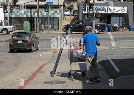 Mann schiebt Einkaufswagen gefüllt mit leeren Flaschen und Müll Sunset Blvd in Echo Park Nachbarschaft von LA Los Angeles Kalifornien USA KATHY DEWITT Stockfoto