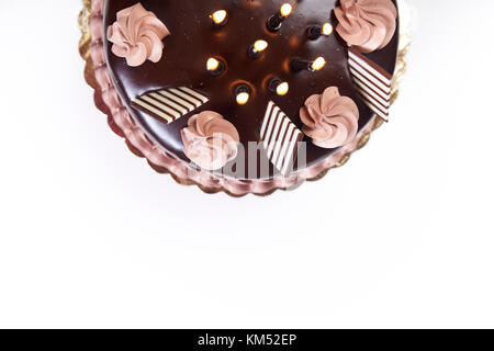 Blick von oben auf die Hälfte der chockolate Geburtstagskuchen mit Kerzen auf weißem Hintergrund closeup Stockfoto