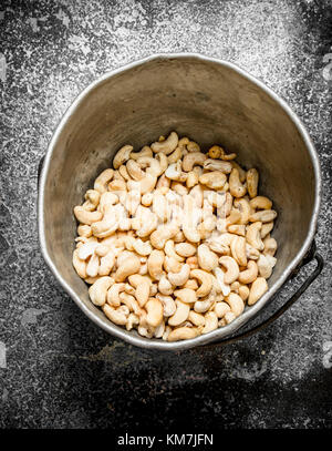 Cashewkerne in der alten Eimer. Auf rustikalen Hintergrund. Stockfoto