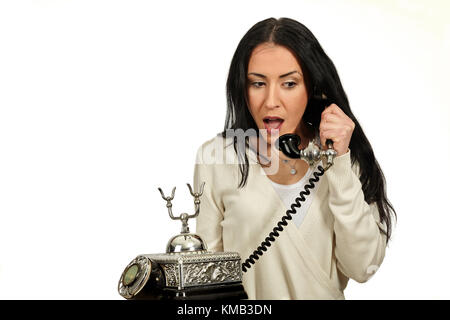 Frau spricht auf einem vintage Telefon. Sie ist surpising. Stockfoto