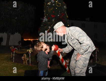 Der Kommandant der 61. Air Base Group, Col Charles Roberts, und einige seiner kleinen Helfer drehten den Schalter, um den Weihnachtsbaum in der Nähe des Paradegeländes auf Fort MacArthur, San Pedro, Kalifornien, anzuzünden, 29. November 2017. Anschließend wurden Familie, Freunde und Bewohner von Basiswohnungen mit Snacks, Spielzeug, Kunsthandwerk und einem Besuch mit dem Weihnachtsmann im Gemeindezentrum verwöhnt, um die Urlaubsstimmung in Gang zu bringen. (USA Luftwaffe Stockfoto