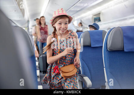 Lächelnd, begieriges Mädchen, das mit dem Flugzeug steigt Stockfoto