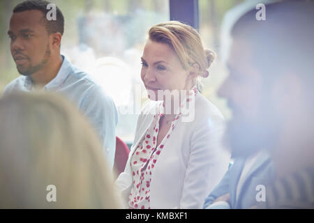 Frau, die in der Gruppentherapie-Sitzung zuhört Stockfoto