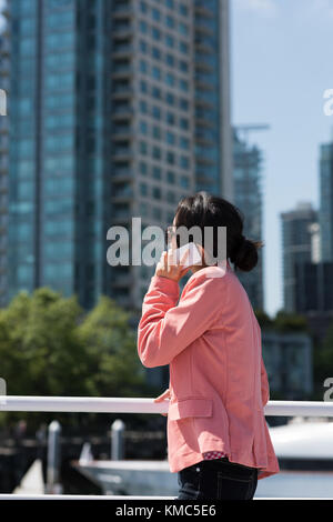 Asiatische Frau telefoniert mit einer Fähre Stockfoto