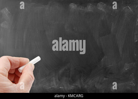 Hand stück Kreide auf leere Tafel Stockfoto