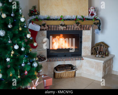 Hintergrund des neuen Jahres mit einem Kamin und einem Weihnachtsbaum. Festliche Stimmung Stockfoto