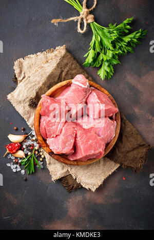 Rohes gehacktes Fleisch mit Gewürzen auf Rusty Hintergrund Stockfoto