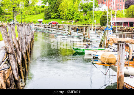 Rockport, USA - Juni 9, 2017: leere Marina Hafen in einem kleinen Dorf in Maine bei Regen mit Booten und Blick auf die Innenstadt, verankerte viele Segelboot angedockt Stockfoto