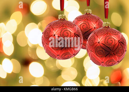 Schöne Weihnachten Dekoration - rote Kugeln auf einem Hintergrund von verschwommen Lichter am Weihnachtsbaum mit bokeh Wirkung. Stockfoto