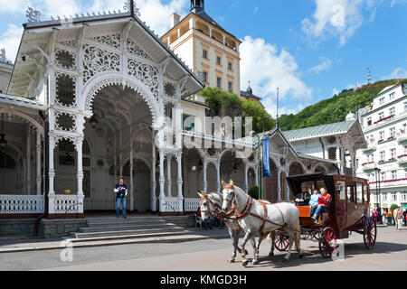 Karlsbad, Tschechische Republik - 6. Juni 2013: Pferdekutsche in der Nähe von kolonnade und trzni schloss Turm mit heißen Quellen, Karlsbad, Tschechische Stockfoto