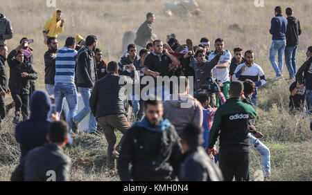 Gaza. Dezember 2017. Ein verwundeter palästinensischer Demonstrant wird während Zusammenstößen mit israelischen Truppen evakuiert, nachdem die USA am 8. Dezember 2017 gegen die Anerkennung Jerusalems als israelische Hauptstadt nahe Osten von Gaza-Stadt protestiert hatten. Schätzungsweise 4.500 palästinensische Demonstranten nahmen an sechs Orten entlang der Grenze zum Gazastreifen am Freitag gegen die Anerkennung Jerusalems als israelische Hauptstadt durch die USA Teil, so eine Erklärung der israelischen Verteidigungskräfte (IDF) am Freitagabend. Quelle: Wissam Nassar/Xinhua/Alamy Live News Stockfoto
