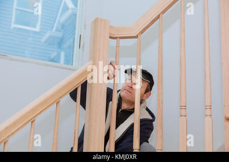 Der Installation Wizard für Holz- Geländer für Treppen Holzbohlen Schwingen um den Pol. Erfolg Business Konzept. Abstrakte Wendeltreppe Wendeltreppe ins Stockfoto