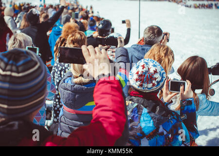 Sheregesh, Kemerovo Region, Russland - 16. April 2016: Aufnahme von Video mit Smartphone während einer Skiabfahrt in Sibirien auf dem Festival Stockfoto