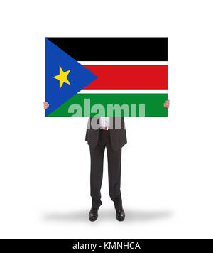 Geschäftsmann mit einer großen Karte, Flagge von South Sudan, isoliert auf weißem Stockfoto