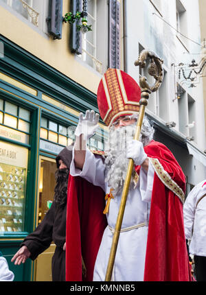 Luzern, Schweiz - 2 Dez 2017: St. Nikolaus, durch seinen Knecht "Knecht Ruprecht" winken zu den Zuschauern wird während der Christmas Parade gefolgt. Stockfoto