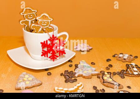 Weihnachten Dekoration: Weihnachten Lebkuchen mit weißem Zuckerguss kleben aus einer Tasse Kaffee Stockfoto