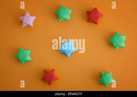 Bunte origami Lucky Stars auf gelben Hintergrund. Close Up. Stockfoto